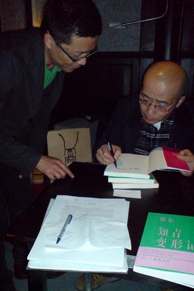 Han Dong signing copies of his new novel
